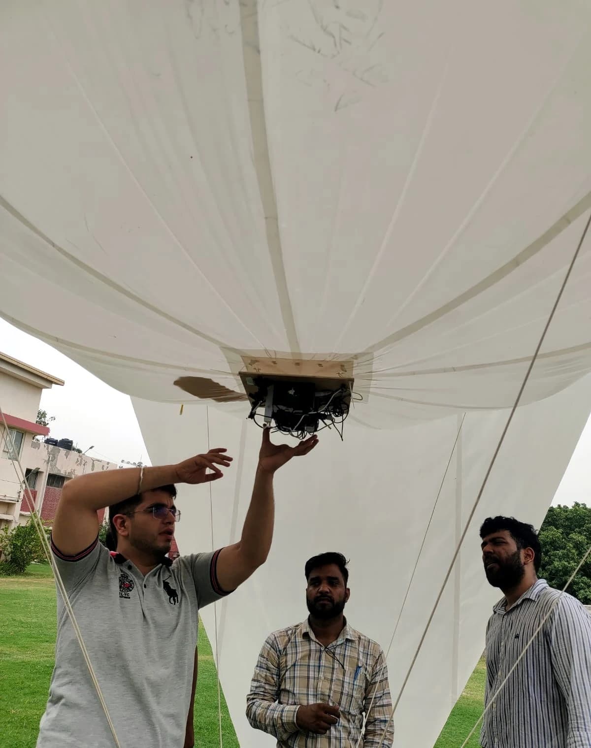 Engineer inspecting the payload mount underneath the aerostat